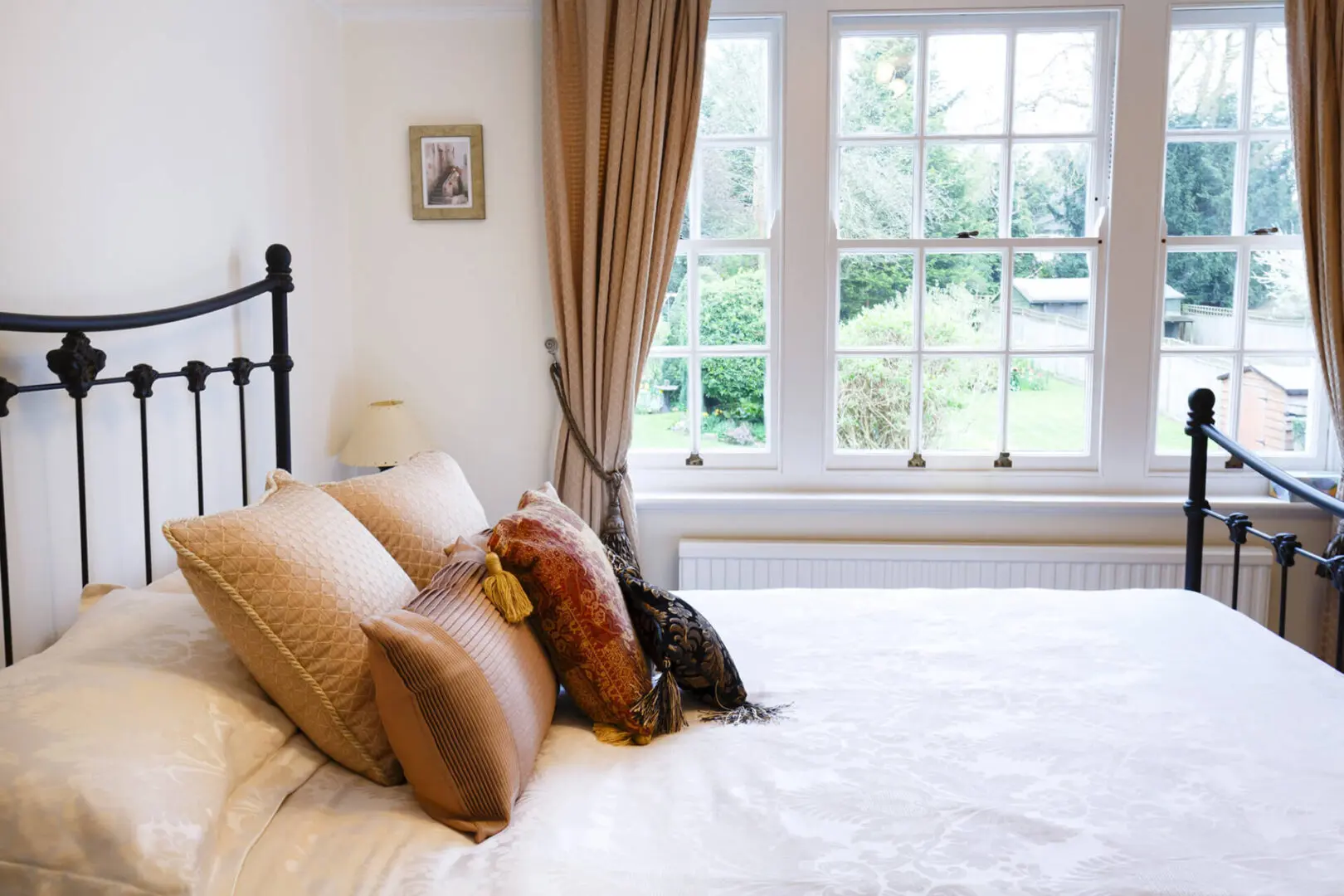 Bedroom of a period British house with sash windows and traditional interior design
